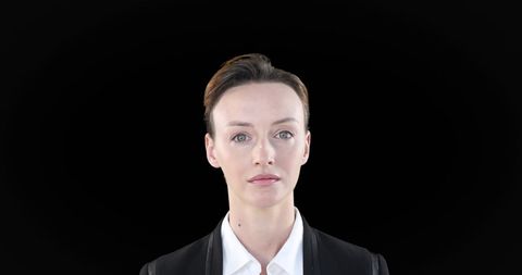 Confident Businesswoman Displaying Leadership on Black Background