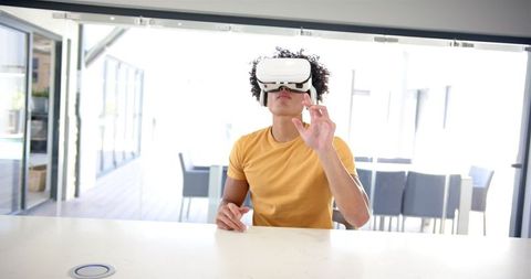 Young Man Engaging with Virtual Reality in Modern Kitchen