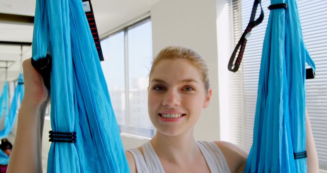 Smiling Woman Holding Aerial Yoga Silks in Bright Studio - Download Free Stock Images Pikwizard.com