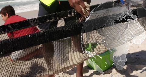 Volunteers utilizing net for beach conservation efforts