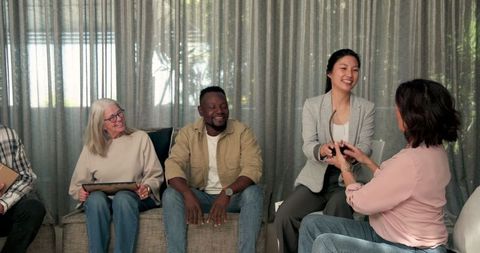 Diverse group therapy session with award ceremony