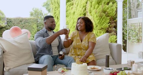 Happy Couple Toasting Champagne in Relaxing Outdoor Celebration