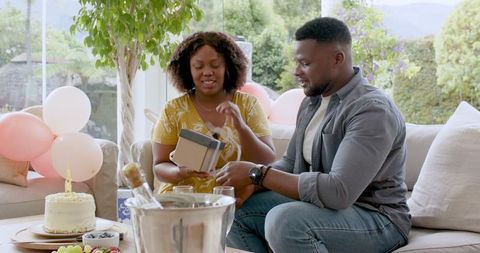 Couple Celebrates Birthday with Cake and Champagne at Home