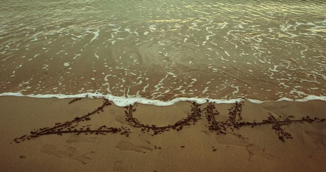 2014 Written in Sand on Ocean Shore at Dusk - Download Free Stock Images Pikwizard.com