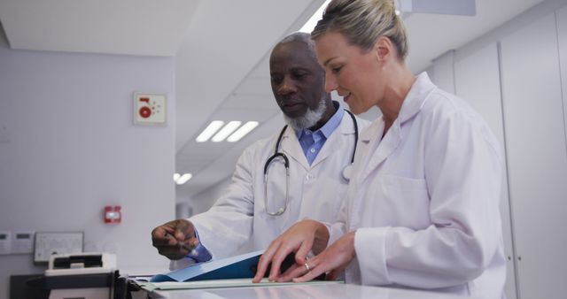 Two Medical Professionals Reviewing Patient Files in Hospital - Download Free Stock Images Pikwizard.com