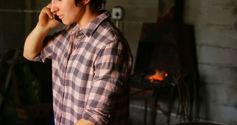 Female Metalsmith Talking on Phone by Forge - Download Free Stock Images Pikwizard.com