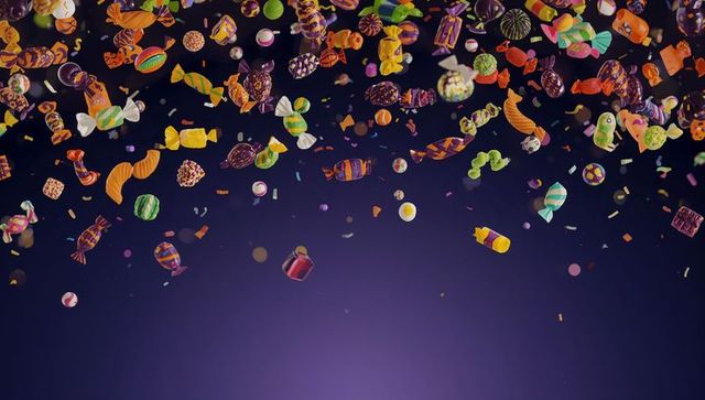 Vibrant assorted candies mid-air against purple background
