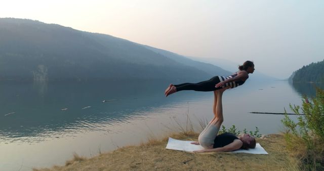 Couple Practicing Acroyoga Outdoors by Lake at Sunrise - Download Free Stock Images Pikwizard.com