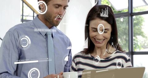 Business professionals reviewing dashboard on laptop with augmented analytics overlays