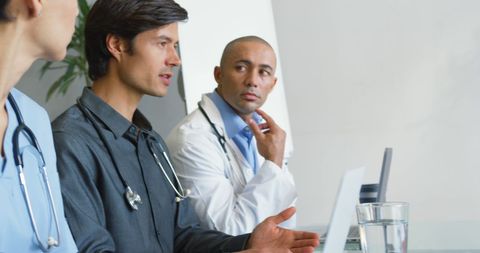 Diverse medical team collaborating in modern hospital office