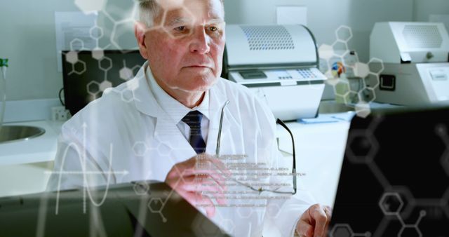 Elderly male scientist working on a computer in a modern laboratory with lab equipment. He appears to be analyzing data related to biochemistry or medicine. This image is perfect for depicting innovation, scientific research, and technological advancements in medical and biochemistry fields.