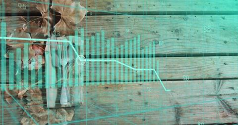 Teal data overlaying rustic wooden tabletop with bar chart and line graph visualization