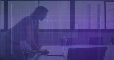 Silhouette of Businesswoman Leaning Over Laptop in Tech-Infused Boardroom with Grid Overlay