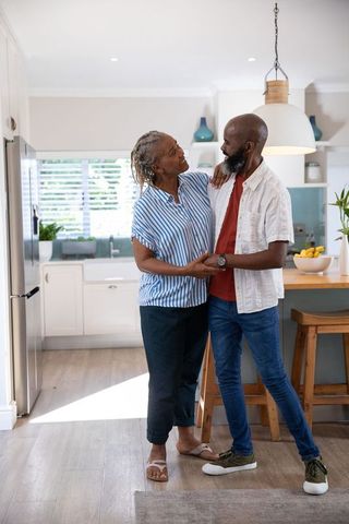 Senior couple sharing happiness in modern kitchen