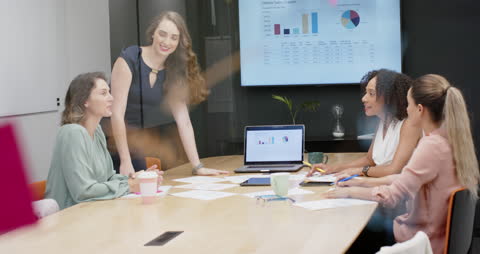 Diverse Business Meeting with Laptops and Charts in Office