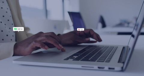 Businesswoman Typing on Laptop in Modern Office with Digital Overlays