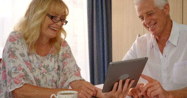 Senior Couple Using Digital Tablet at Home Enjoying Technology - Download Free Stock Images Pikwizard.com