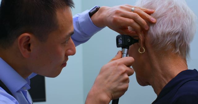 Doctor examining elderly woman with otoscope in clinic - Download Free Stock Images Pikwizard.com