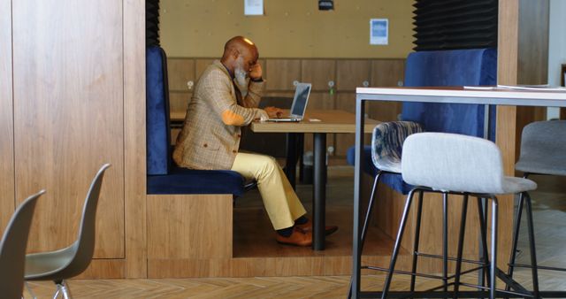 Businessman Working on Laptop in Modern Office Booth - Download Free Stock Images Pikwizard.com