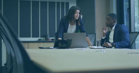 Professional team collaborating in modern boardroom