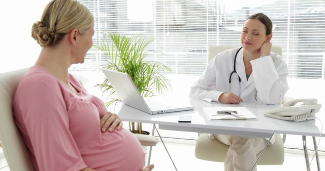 Pregnant Woman Consulting with Doctor in Bright Modern Office - Download Free Stock Images Pikwizard.com