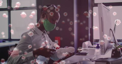 African American Businesswoman Disinfects Office during Pandemic