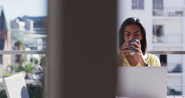 Focused Businesswoman Drinking Coffee on Urban Balcony - Download Free Stock Images Pikwizard.com