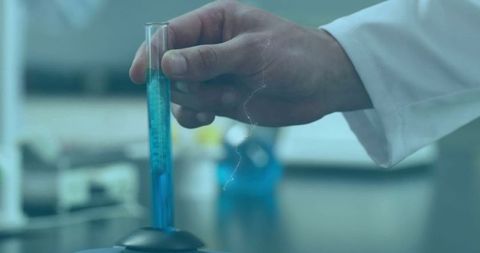Scientist Holding Test Tube Experimenting with Light Trails Effect