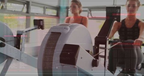 Women rowing indoors with data overlay wellness technology