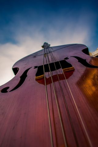 Perspective view of cello with dramatic sky