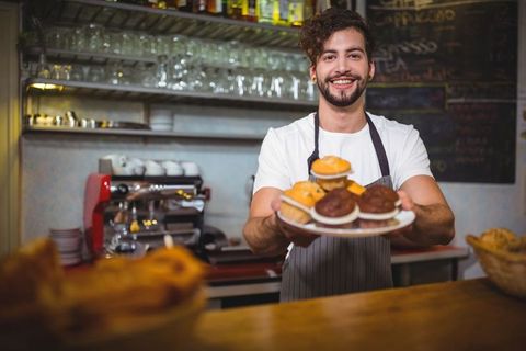 Barista Presenting Freshly Baked Muffins at Trendy Cafe - Download Free Stock Images Pikwizard.com
