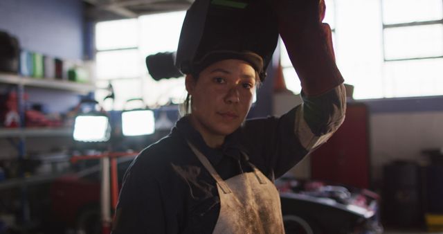 Female Welder Lifting Protective Mask in Industrial Workshop - Download Free Stock Images Pikwizard.com