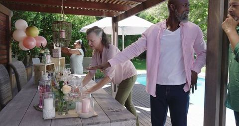 Diverse Seniors Preparing Outdoor Table for Celebration