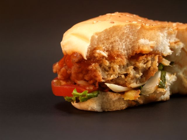 Close-Up of Half-Eaten Veggie Burger with Fresh Ingredients - Download Free Stock Photos Pikwizard.com