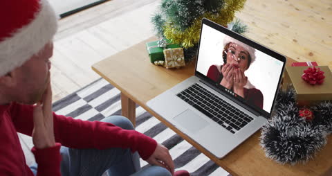 Couple Enjoying Christmas Video Call on Laptop, Blowing Kisses
