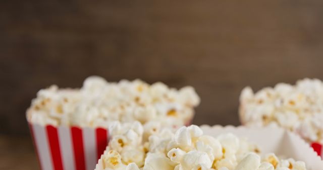 Fresh Popcorn in Striped Boxes on Wooden Background - Download Free Stock Images Pikwizard.com