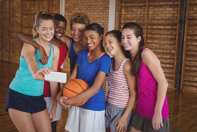 Happy High School Basketball Team Taking Selfie in Gym - Download Free Stock Photos Pikwizard.com