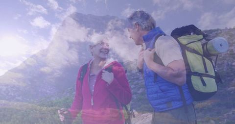Senior couple enjoying mountain hike under clear skies