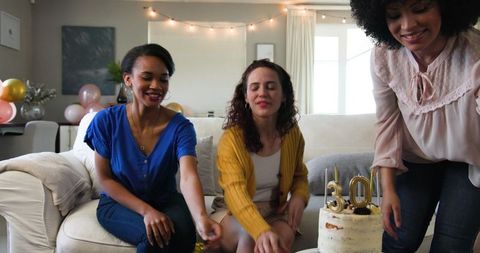 Women Celebrating Birthday in Festive Living Room Setting