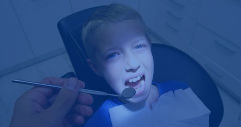 Curious boy at dentist opening mouth for dental examination