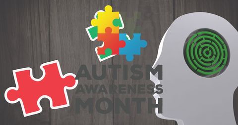 Autism awareness month concept with puzzle pieces and human brain
