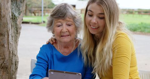 Senior Mother and Daughter Enjoying Selfie Outdoors