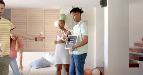 Joyful Home Celebration with Friends Toasting Champagne