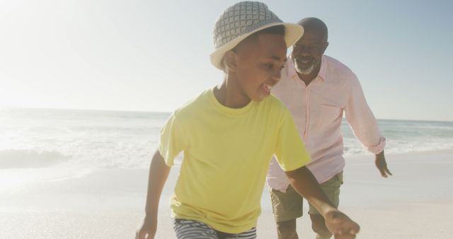 Smiling Grandfather and Grandson Running Happily on Beach - Download Free Stock Images Pikwizard.com