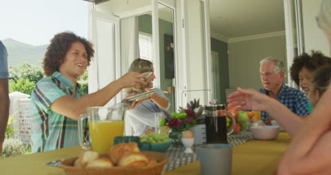 Diverse Multigenerational Family Enjoying Dinner Together at Home