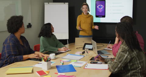 Diverse Team in Strategy Meeting with Presentation