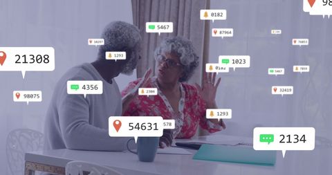 Senior African American Couple Engaging with Digital Technology Over Documents