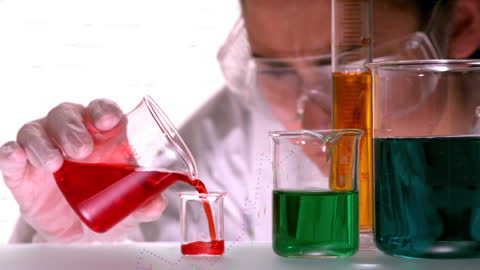 Female Scientist Experimenting with Colorful Liquids in Laboratory