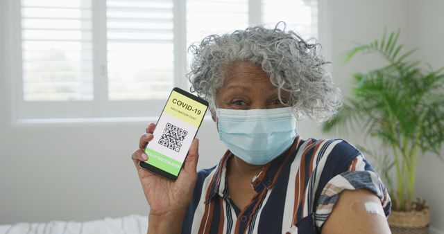 Elderly Woman Showing COVID-19 Vaccination Certificate on Phone - Download Free Stock Images Pikwizard.com