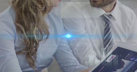 professionals engaged in business discussion while analyzing data abstracted over digital overlay of graphs and statistics. represents modern financial analysis, collaborative work, and the integration of technology in business strategy. can be used to illustrate themes of data-driven decision-making, tech in finance, or corporate meetings.